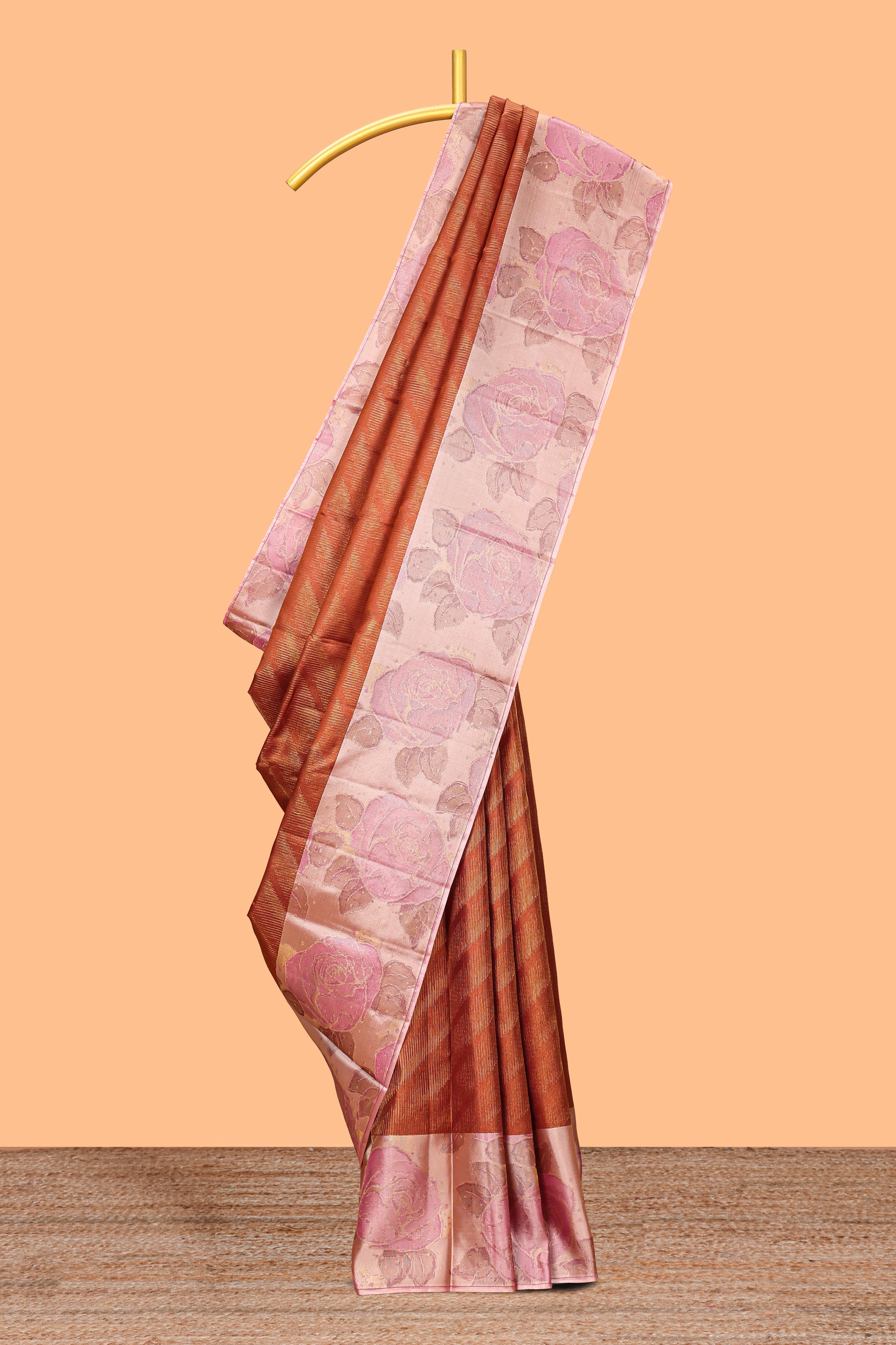 Rust orange geometric design parambariya pattu saree with contrast floral border and motifs blouse