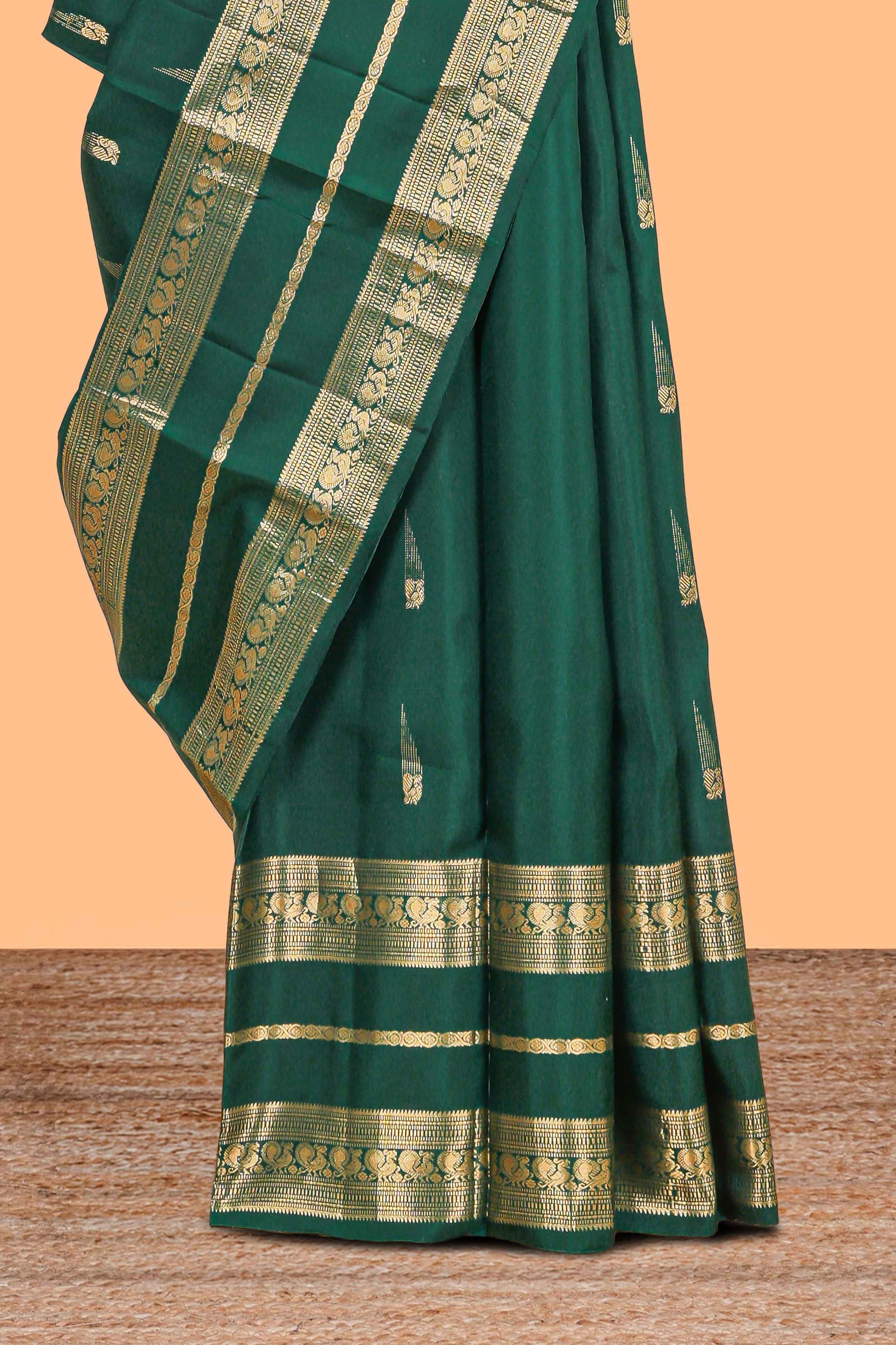 Dark green gold zari butta motifs parambariya pattu saree with self zari border and matching blouse