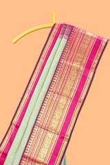 Mint green gold zari butta designed parambariya pattu saree with contrast golden zari border and contrasting pallu beautiful zari design