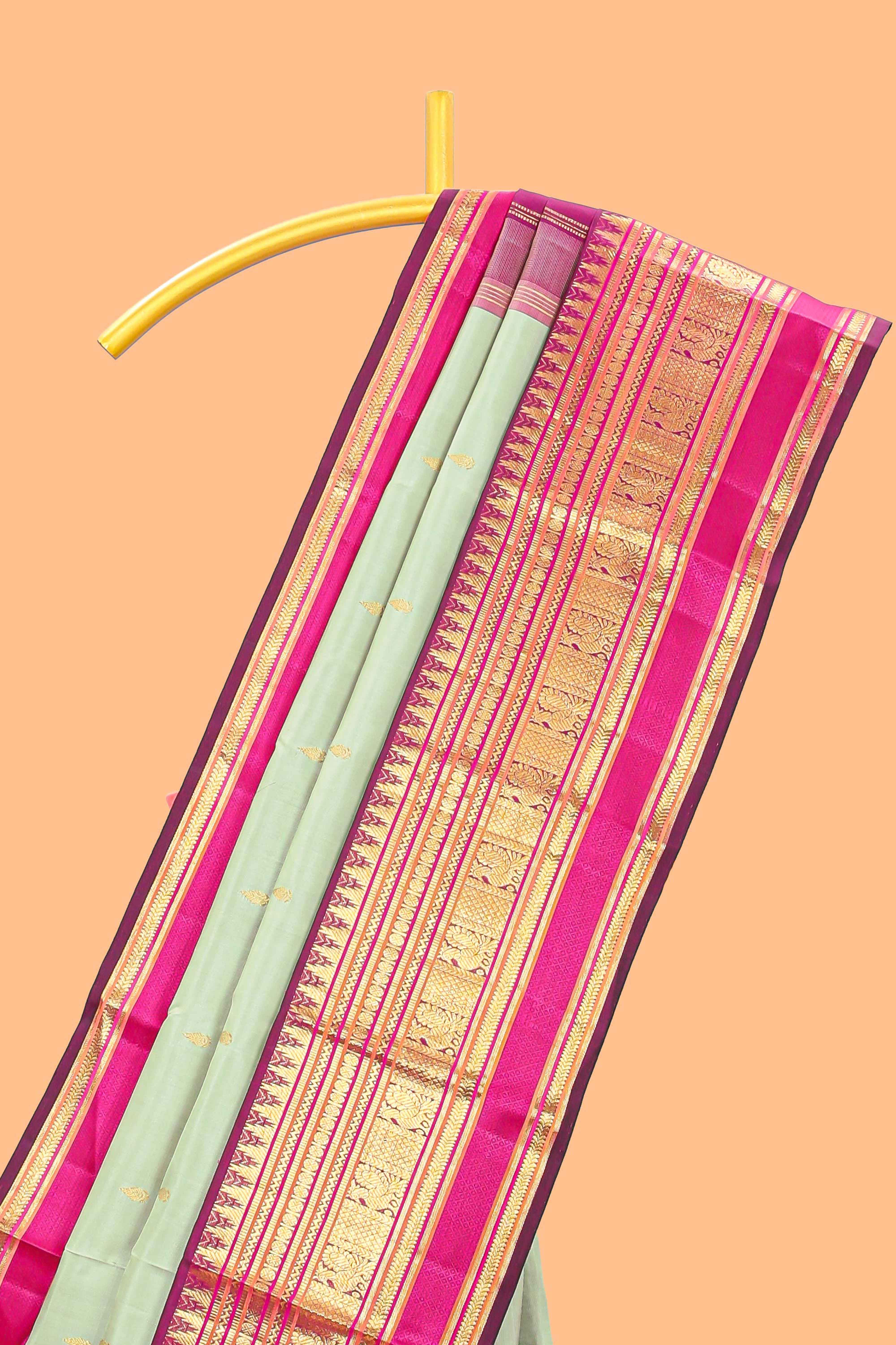 Mint green gold zari butta designed parambariya pattu saree with contrast golden zari border and contrasting pallu beautiful zari design