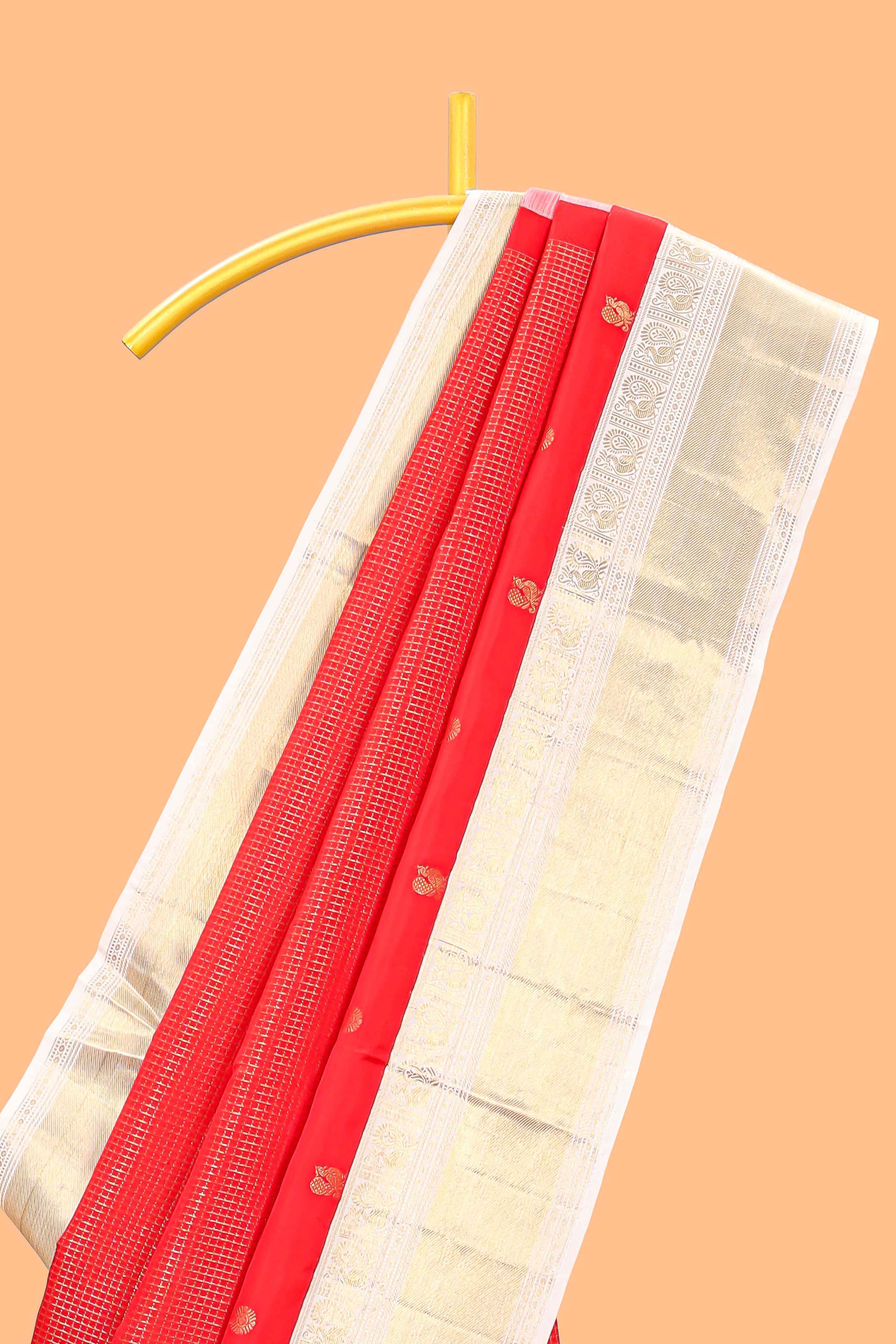 Bright red peacock motifs checked parambariya pattu saree with contrast golden zari border and contrasting pallu designed with geometric patterns and peacock motifs