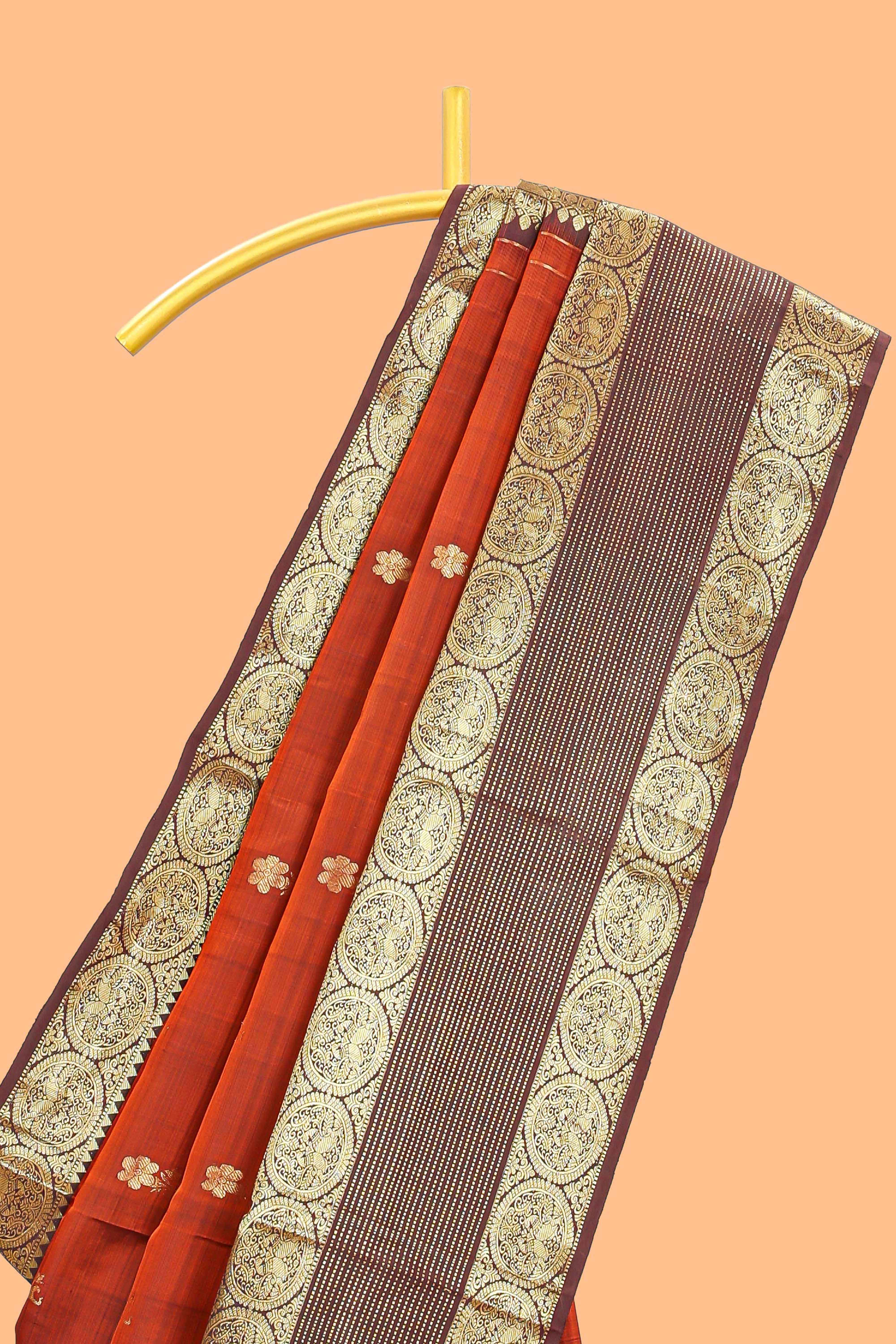 Rust orange butta designed parambariya pattu saree with contrast retta patta zari border and geometric zari designed pallu