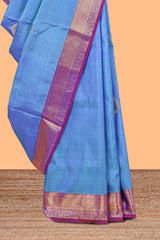 Blue color butta designed parambariya pattu saree with contrast zari border and rich peacock zari motifs pallu