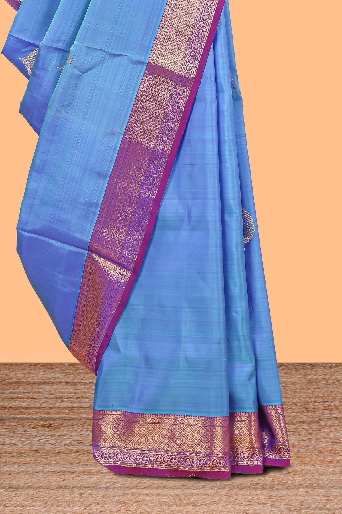 Blue color butta designed parambariya pattu saree with contrast zari border and rich peacock zari motifs pallu