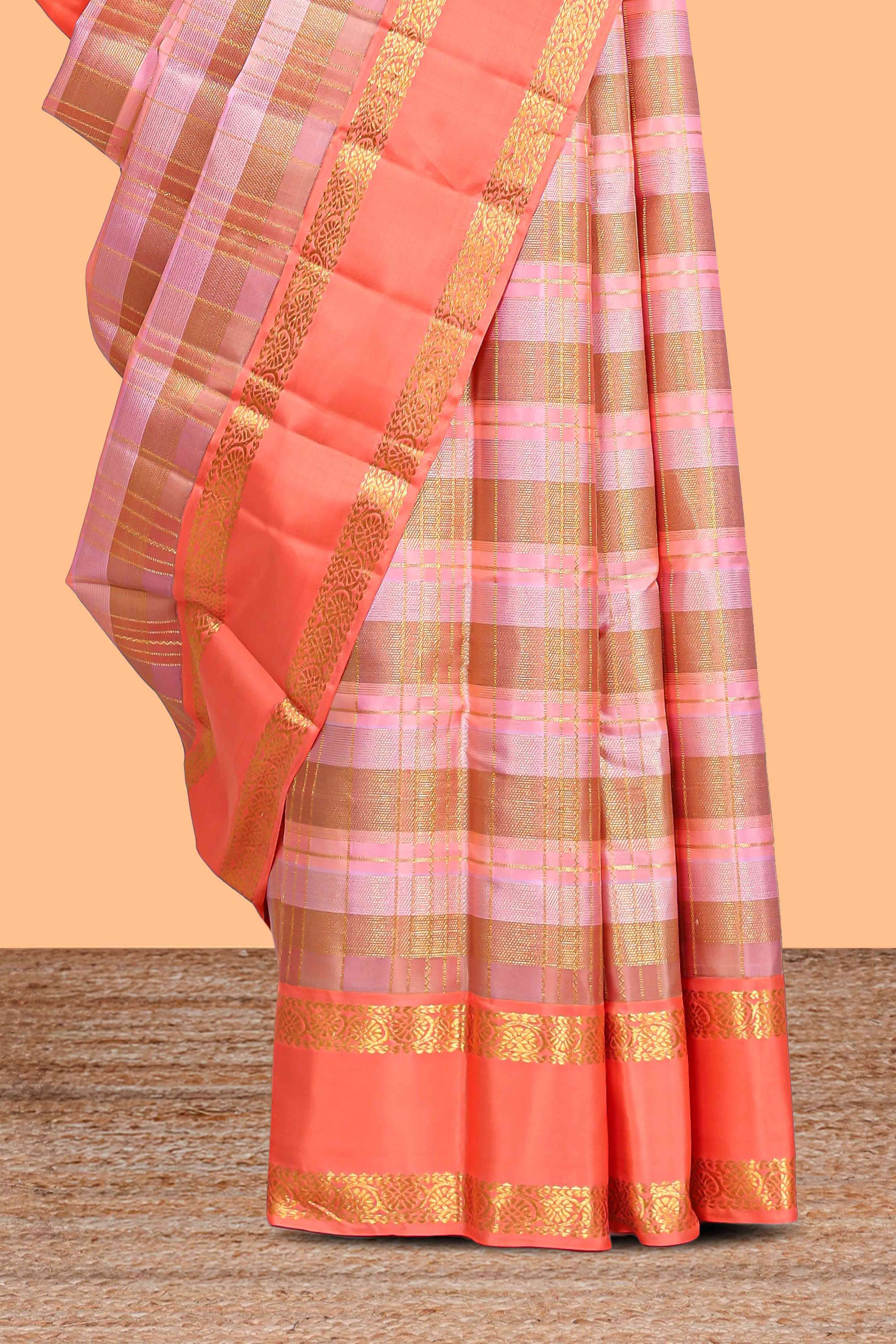 Peach pink with tonal shades checked parambariya pattu saree with contrast border and zari pallu comes with plain blouse