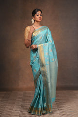 Turquoise blue art silk saree with gold zari woven circular motifs fine vertical zari lines and a rich traditional zari border with woven pallu along with matching blouse
