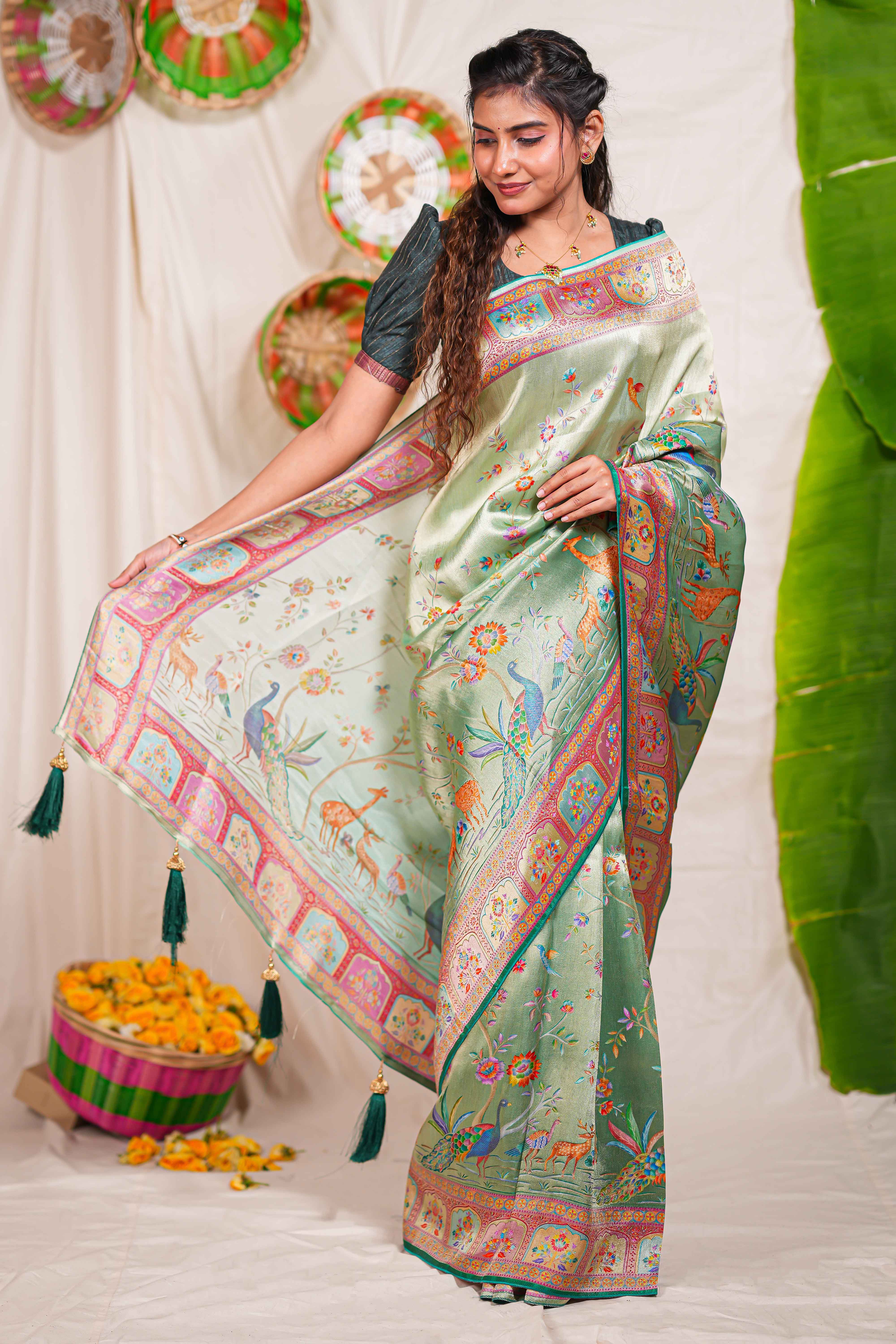 Pastel green floral and animal themed banarasi silk saree with contrast border matching blouse