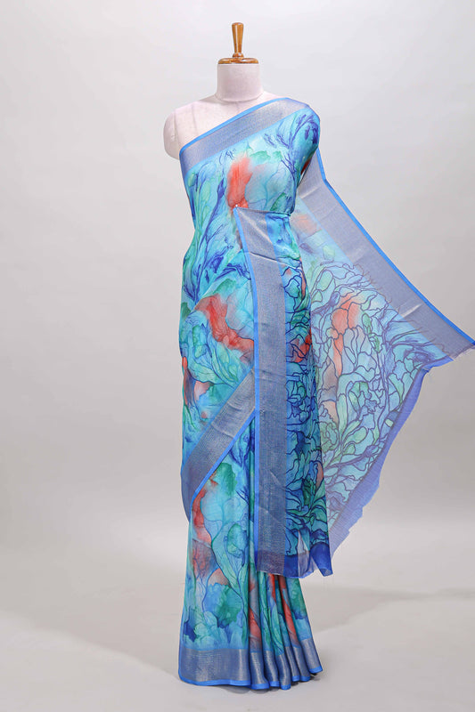 Aqua blue marsh georgette saree with artistic floral digital prints, self zari border and pallu, paired with a matching  blouse