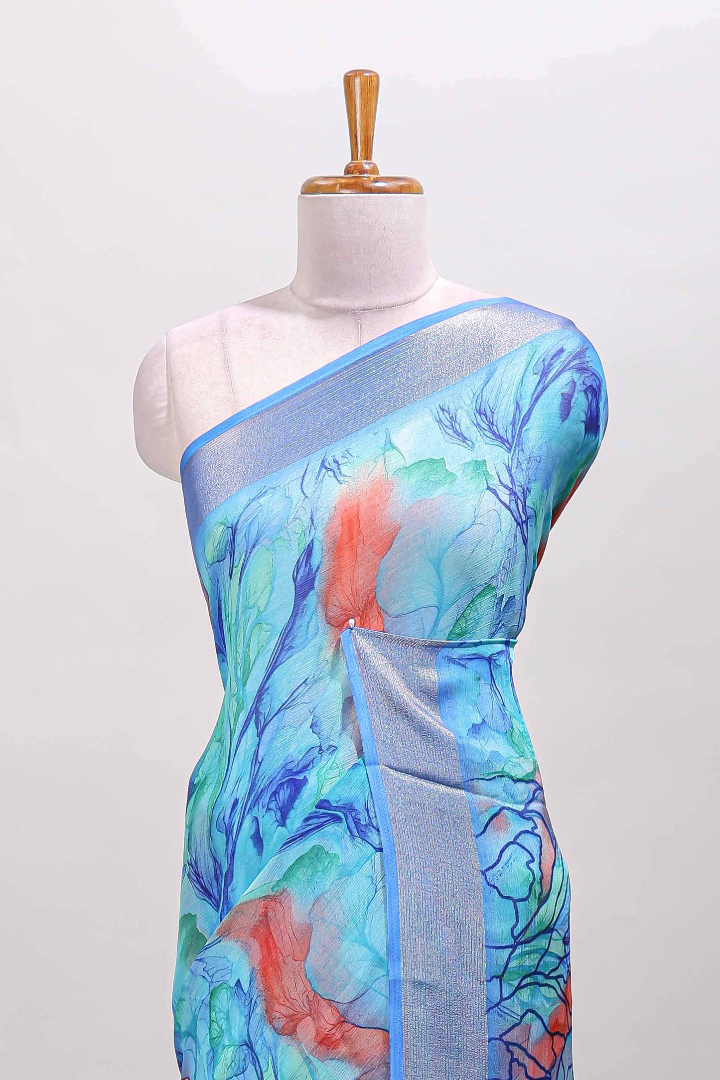 Aqua blue marsh georgette saree with artistic floral digital prints, self zari border and pallu, paired with a matching  blouse