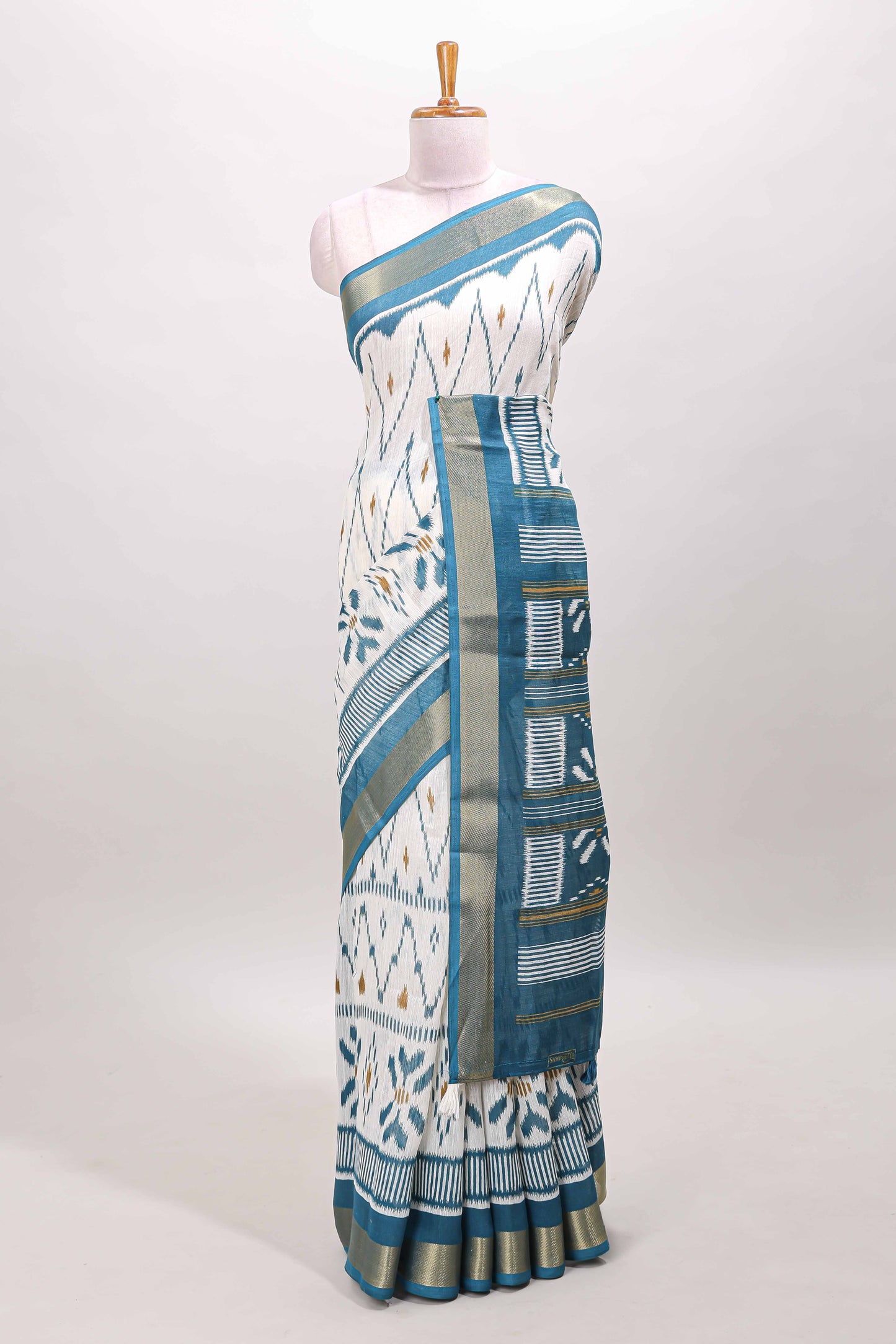 White geometric design ikkat style linen cotton saree with contrast border and striped blouse
