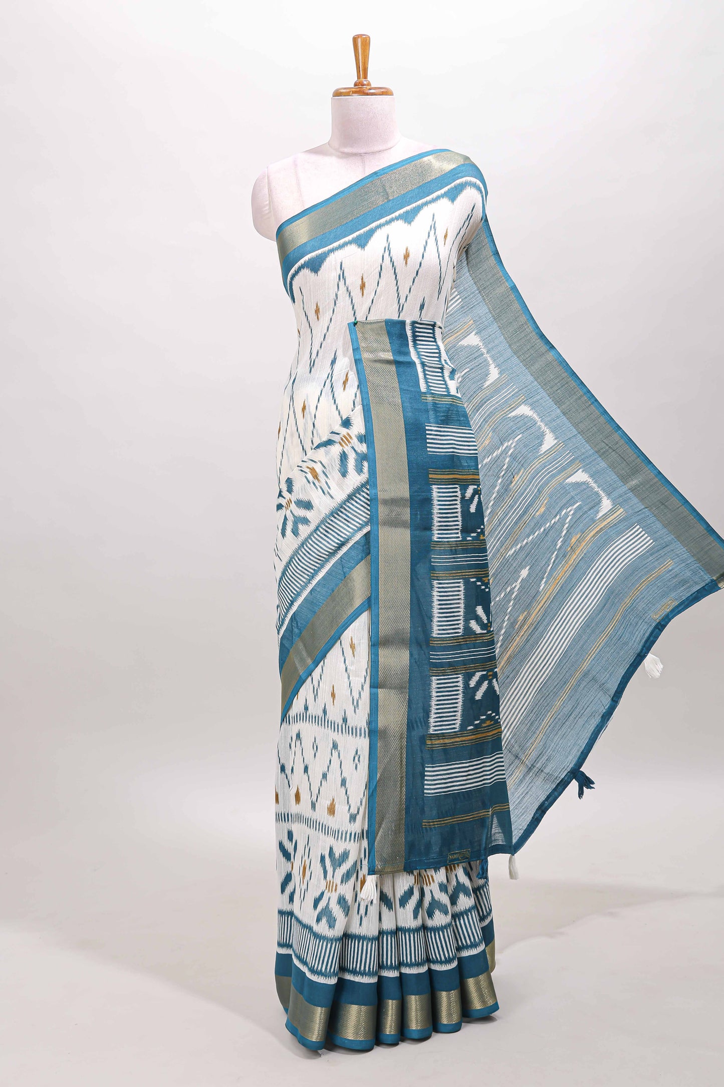 White geometric design ikkat style linen cotton saree with contrast border and striped blouse