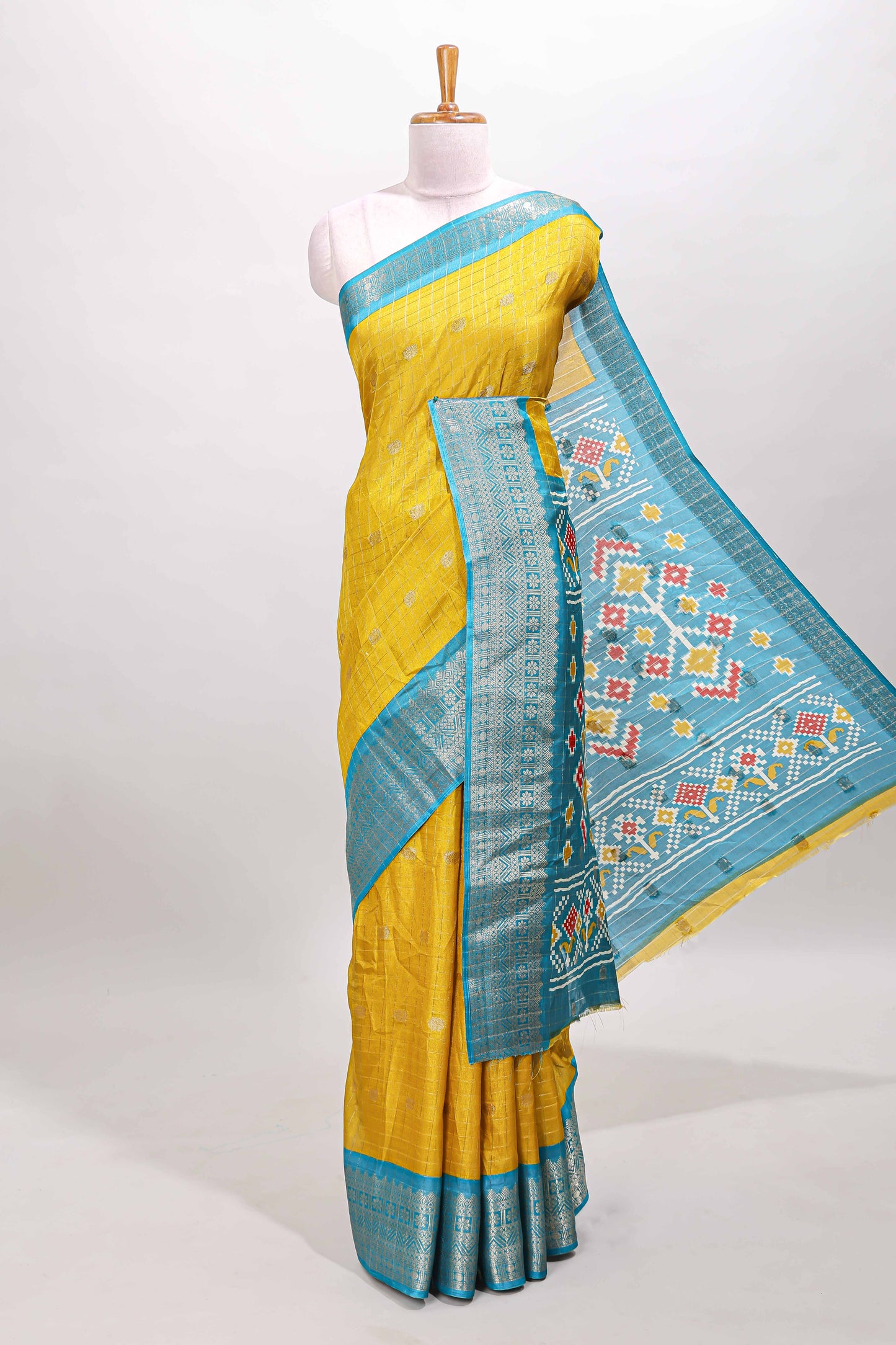 Yellow checked zari butta viscose dola silk saree with contrast zari border and ikkat style pallu