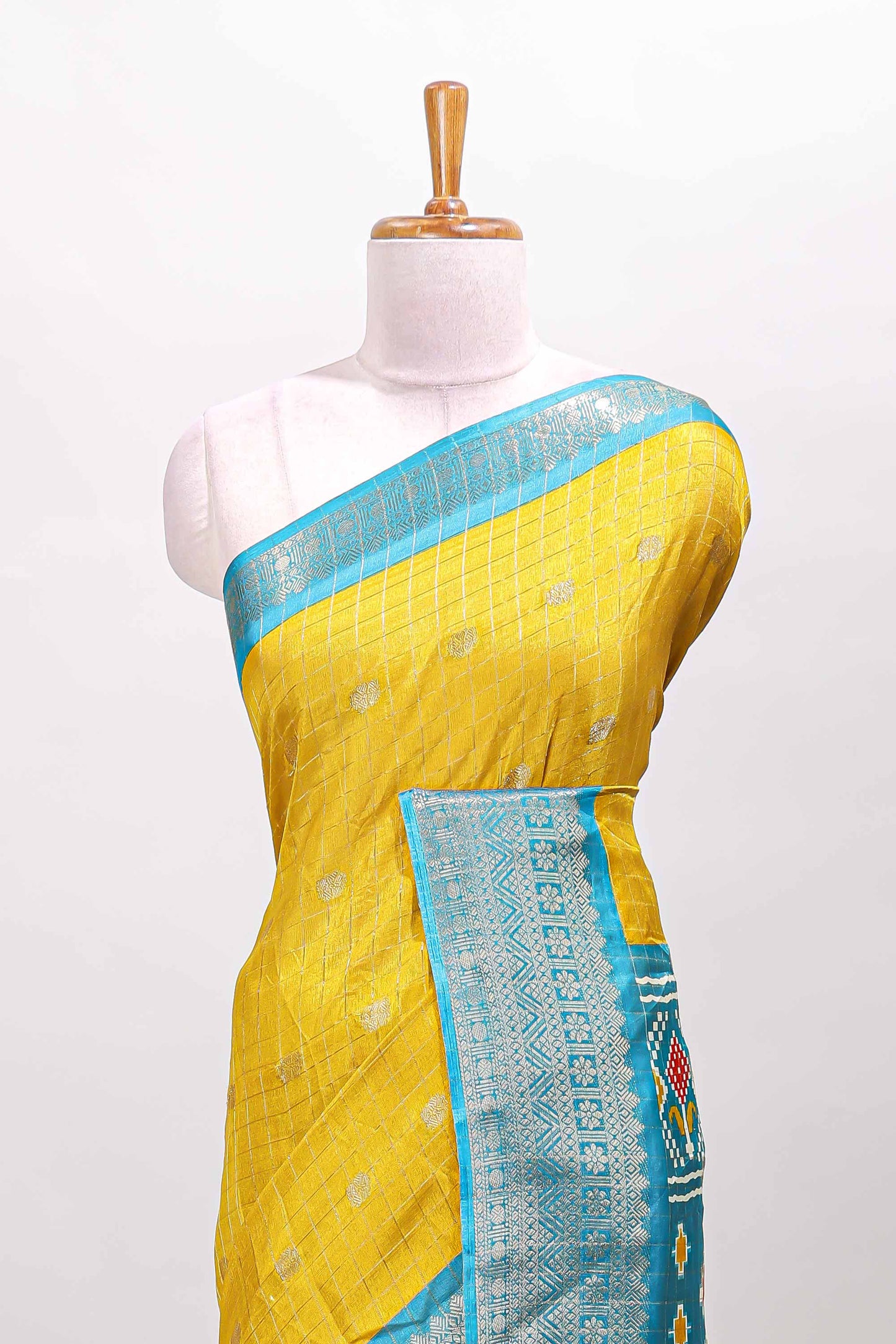 Yellow checked zari butta viscose dola silk saree with contrast zari border and ikkat style pallu