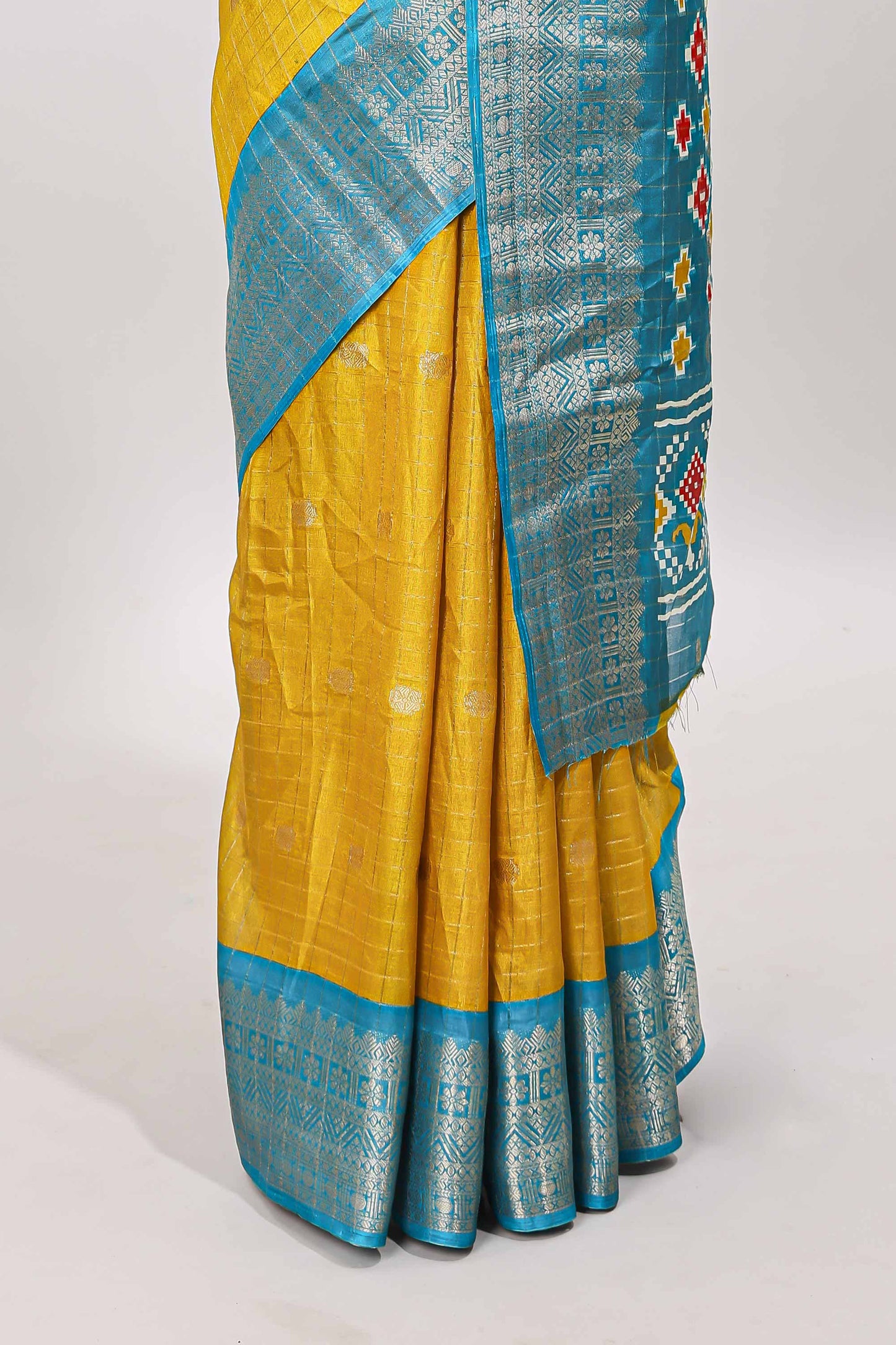 Yellow checked zari butta viscose dola silk saree with contrast zari border and ikkat style pallu