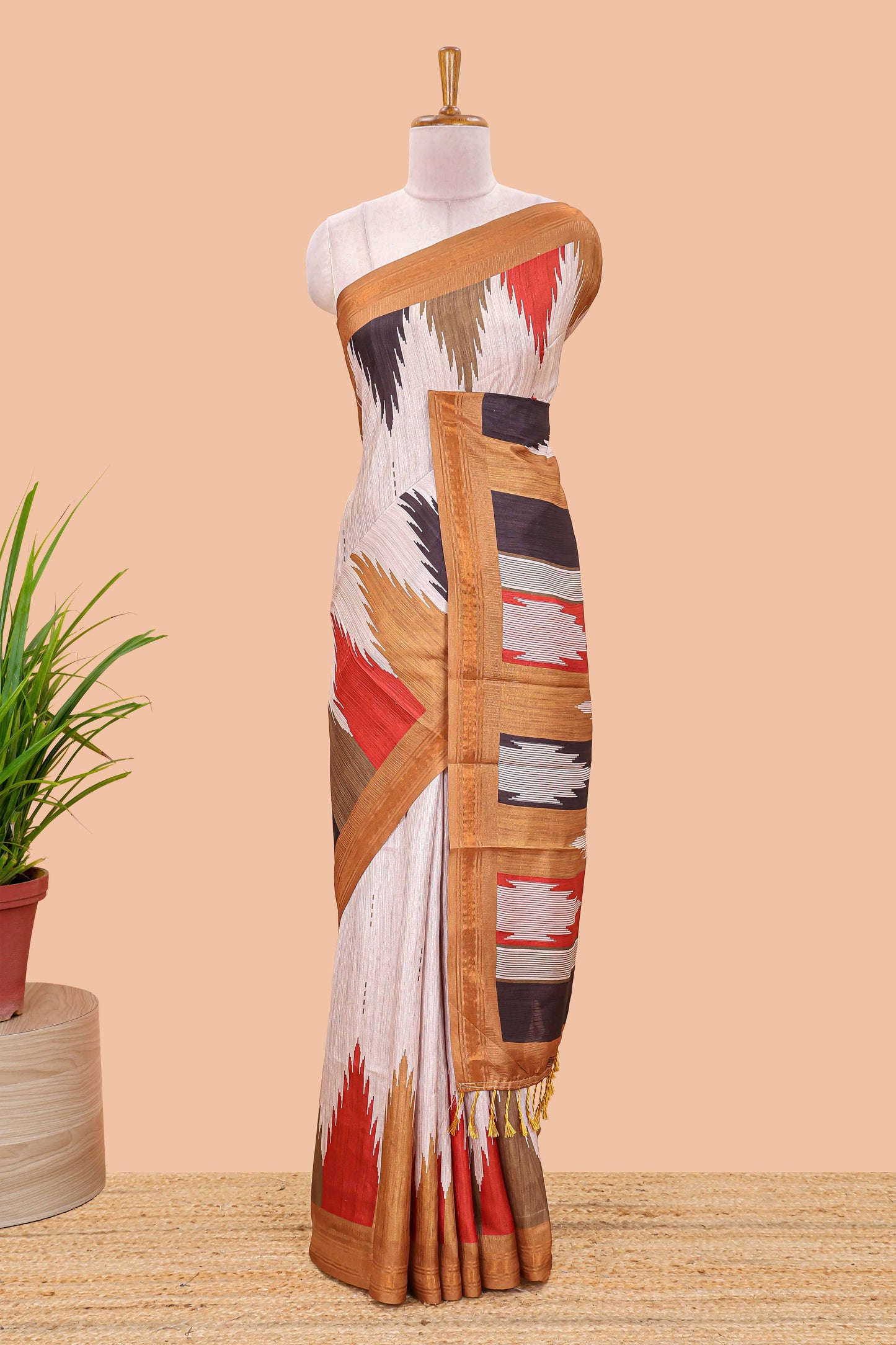 Beige tussar silk saree with chevron ikkat design and geometrical zari border and pallu