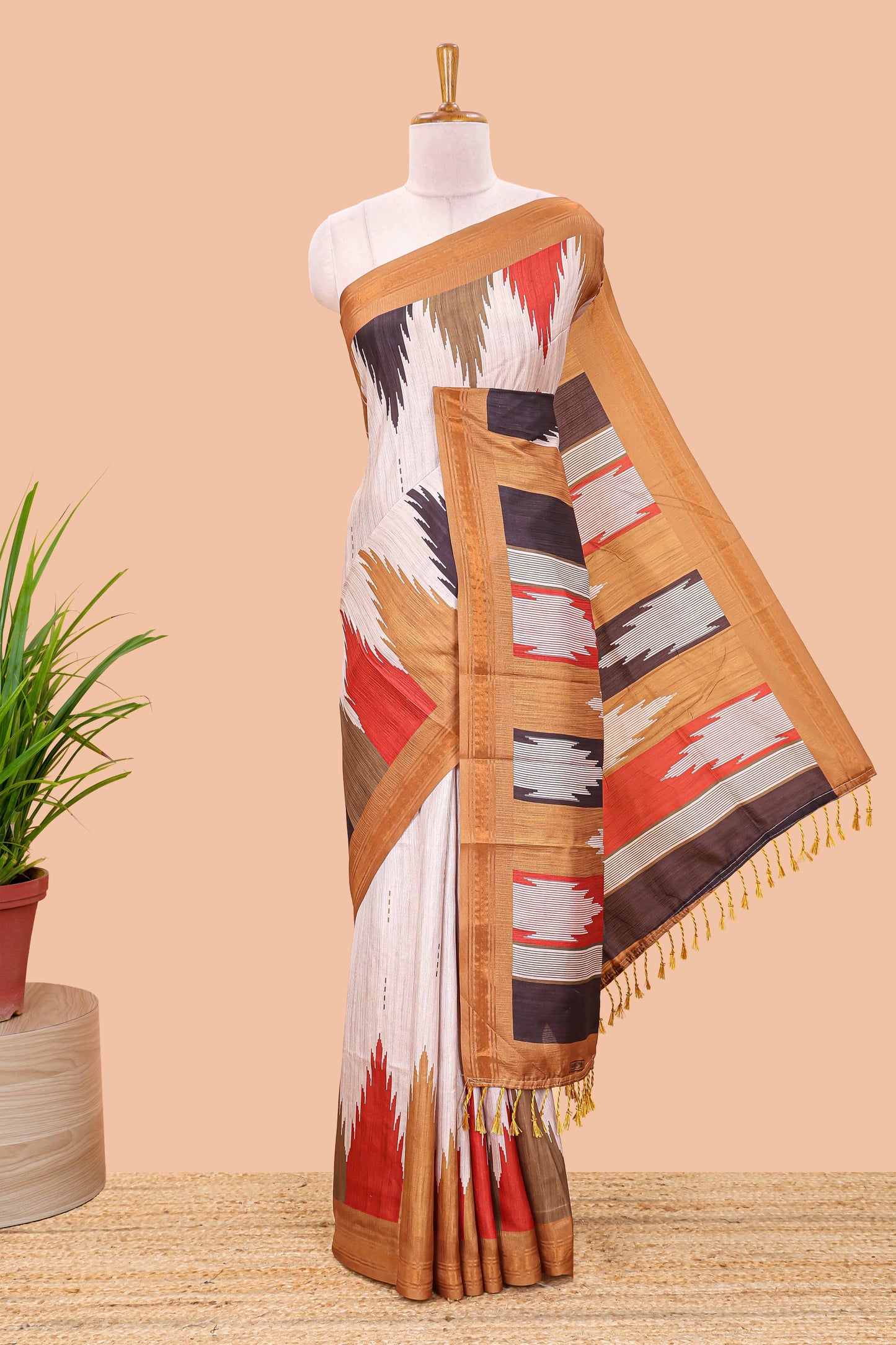 Beige tussar silk saree with chevron ikkat design and geometrical zari border and pallu