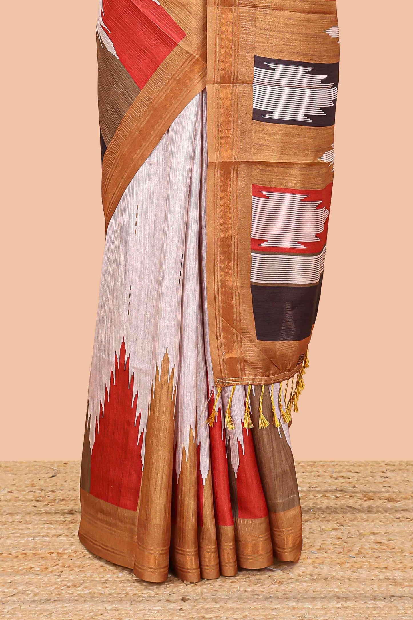 Beige tussar silk saree with chevron ikkat design and geometrical zari border and pallu