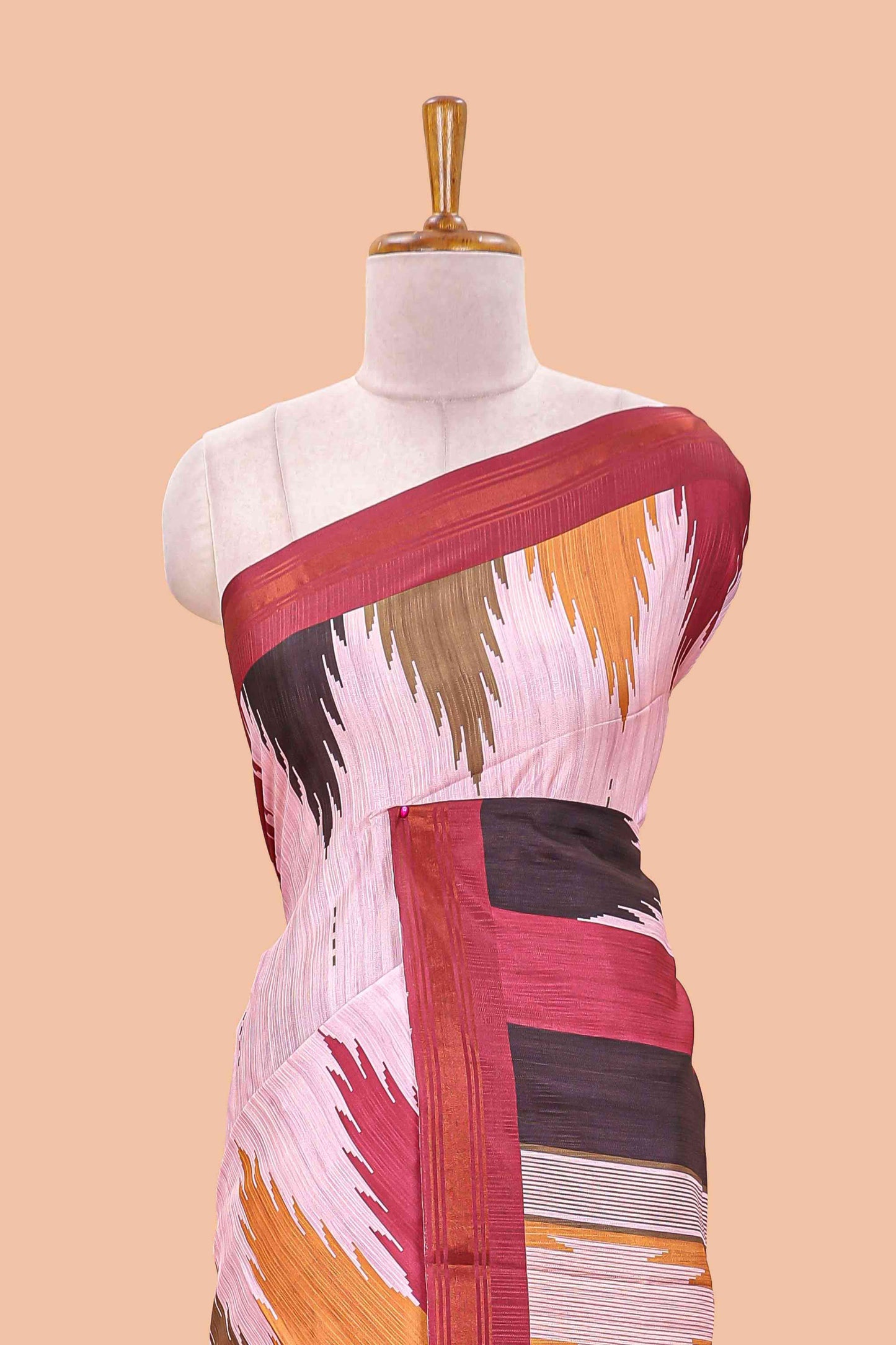 Pink tussar silk saree with chevron ikkat design and geometrical zari border and pallu