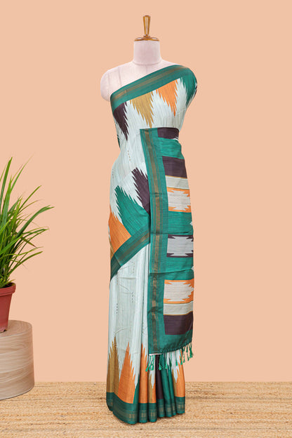 Green tussar silk saree with chevron ikkat design and geometrical zari border and pallu