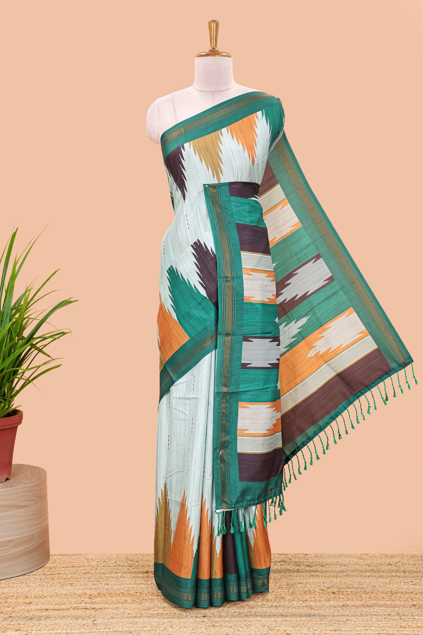 Green tussar silk saree with chevron ikkat design and geometrical zari border and pallu