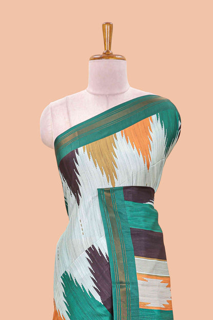 Green tussar silk saree with chevron ikkat design and geometrical zari border and pallu