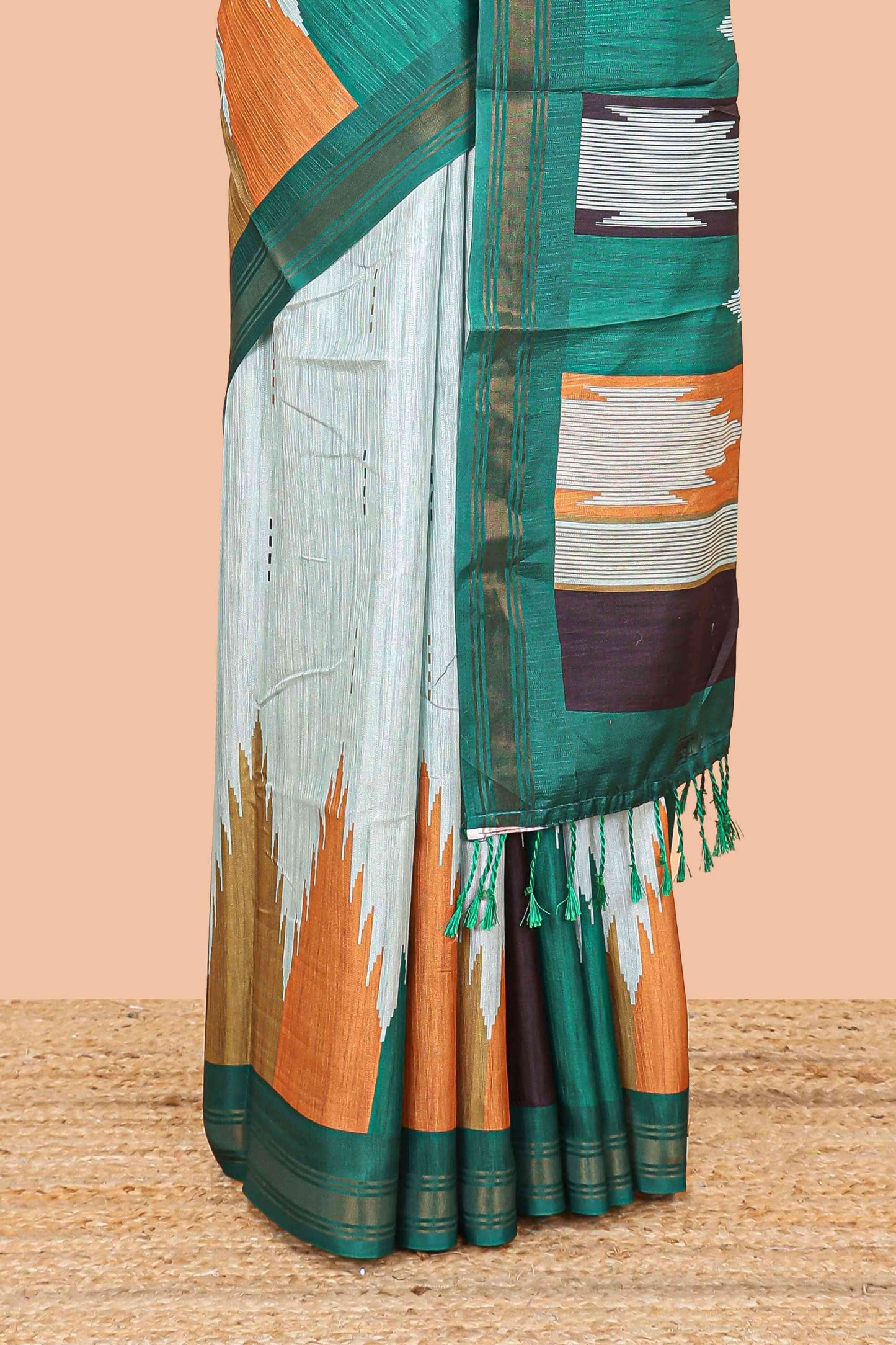 Green tussar silk saree with chevron ikkat design and geometrical zari border and pallu