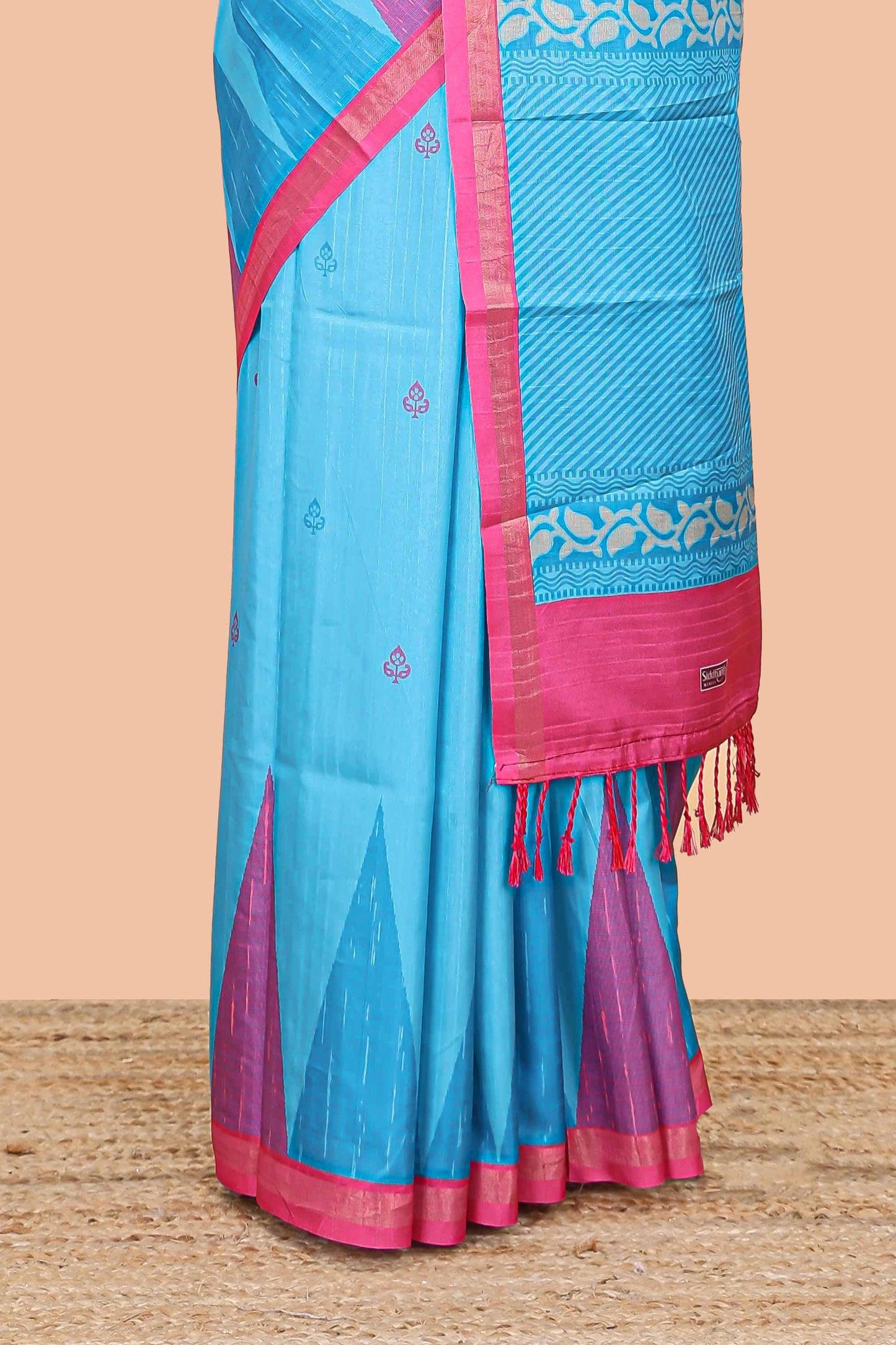 Blue semi tussar silk saree with all over paisley butta, geometric ikkat pattern and zari border