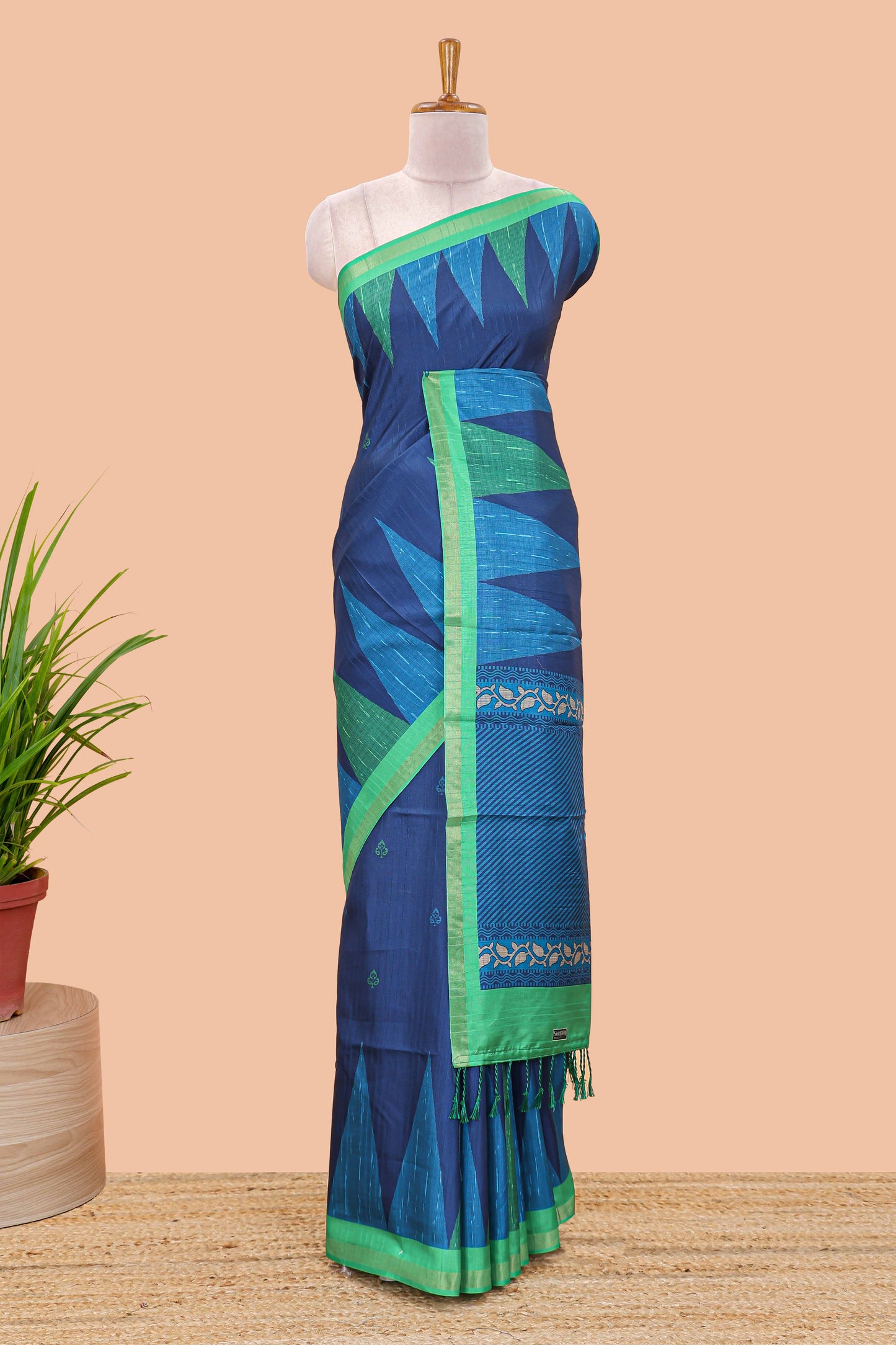 Blue semi tussar silk saree with all over paisley butta, geometric ikkat pattern and zari border