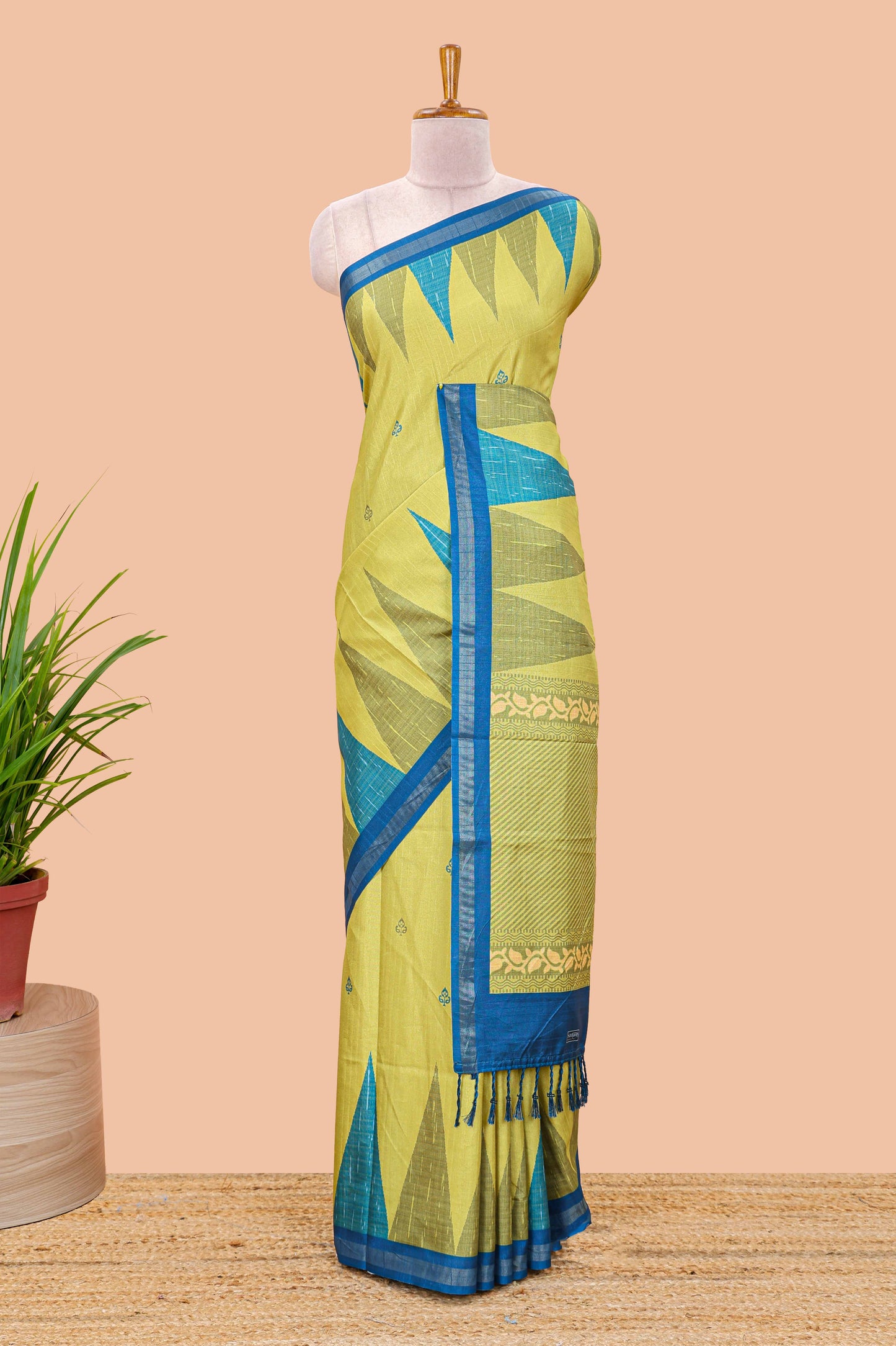 Green semi tussar silk saree with all over paisley butta, geometric ikkat pattern and zari border