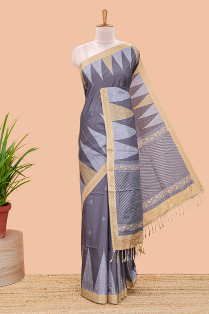 Grey semi tussar silk saree with all over paisley butta, geometric ikkat pattern and zari border