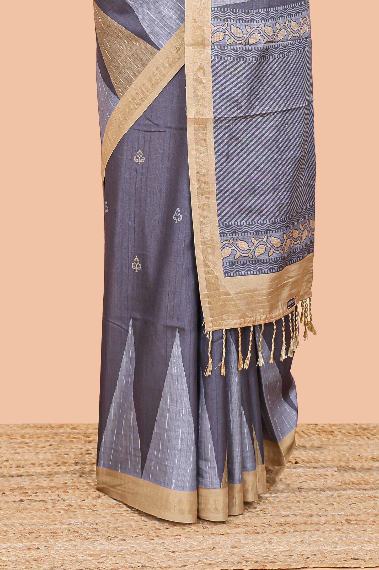 Grey semi tussar silk saree with all over paisley butta, geometric ikkat pattern and zari border
