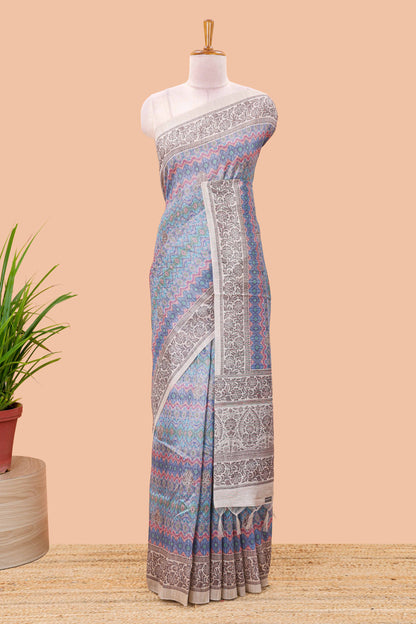 Blue chanderi cotton saree featuring ikkat style jaal print and contrast floral border and pallu