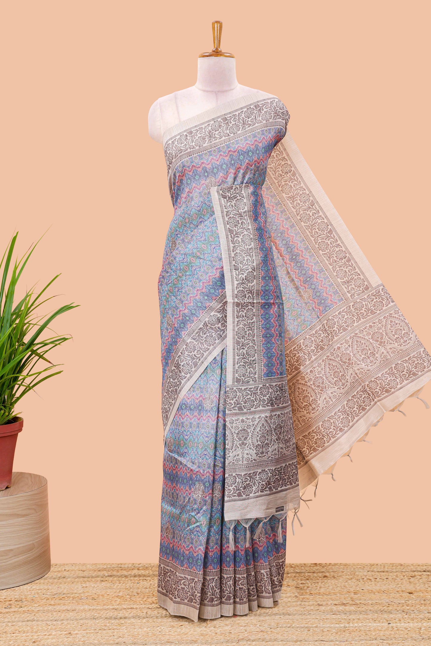 Blue chanderi cotton saree featuring ikkat style jaal print and contrast floral border and pallu