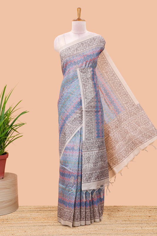 Blue chanderi cotton saree featuring ikkat style jaal print and contrast floral border and pallu