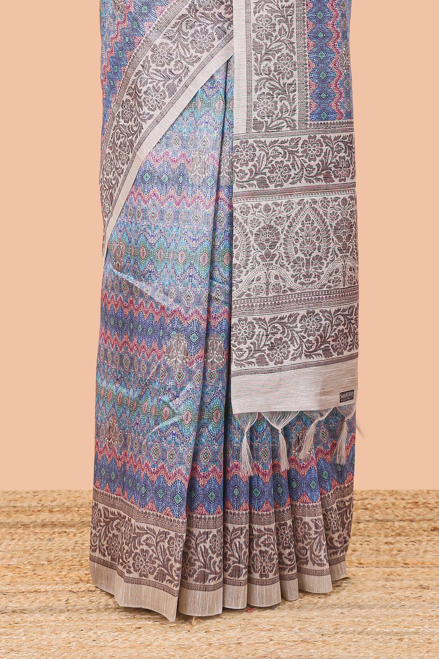 Blue chanderi cotton saree featuring ikkat style jaal print and contrast floral border and pallu