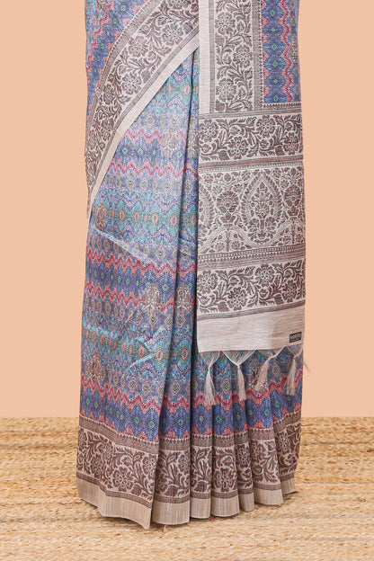 Blue chanderi cotton saree featuring ikkat style jaal print and contrast floral border and pallu