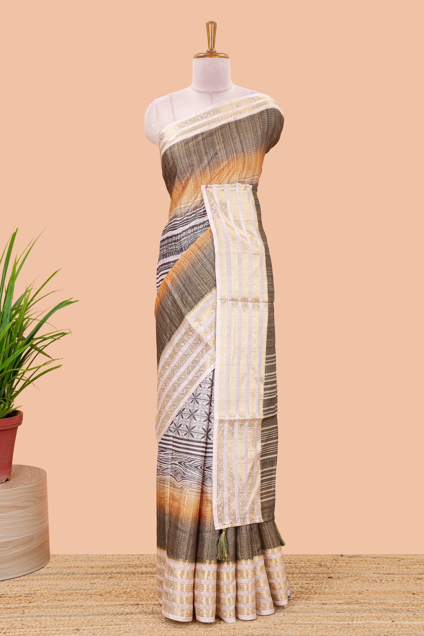 Olive green dola silk saree featuring geometric block print and contrast zari border