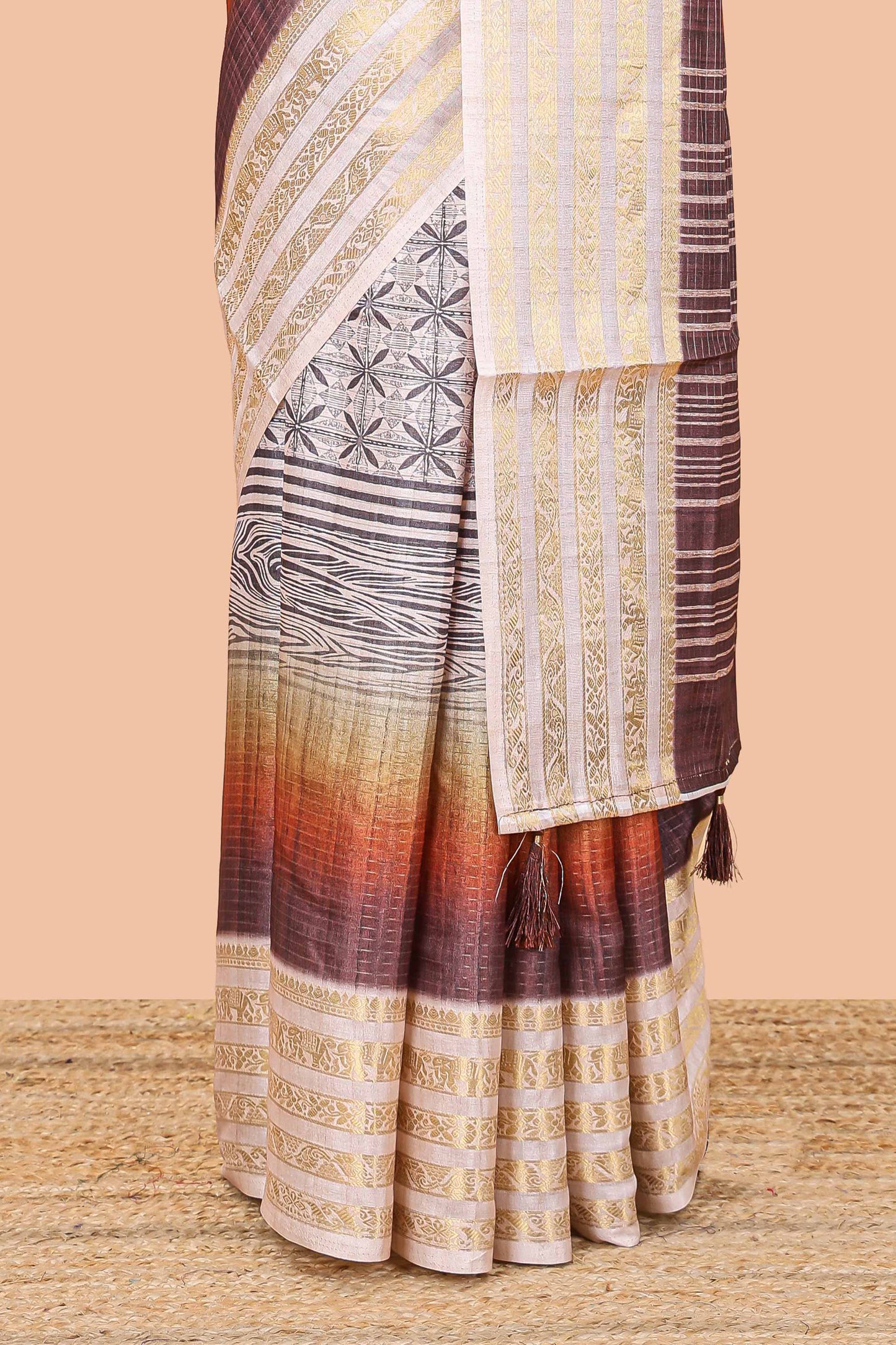 Brown dola silk saree featuring geometric block print and contrast zari border