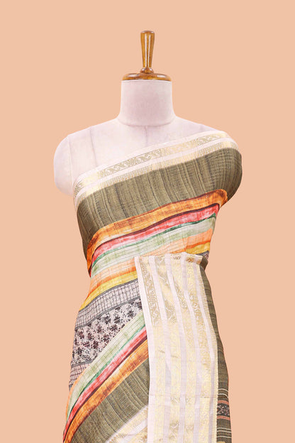 Green dola silk saree featuring monochrome fusion print and contrast zari border