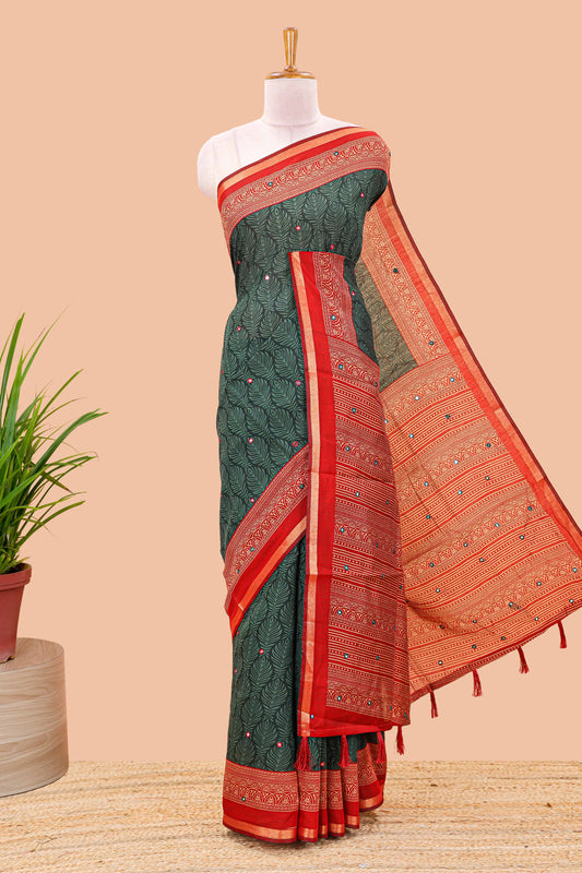 Green chanderi cotton saree with all over peacock feather print, mirror work, contrast border and pallu