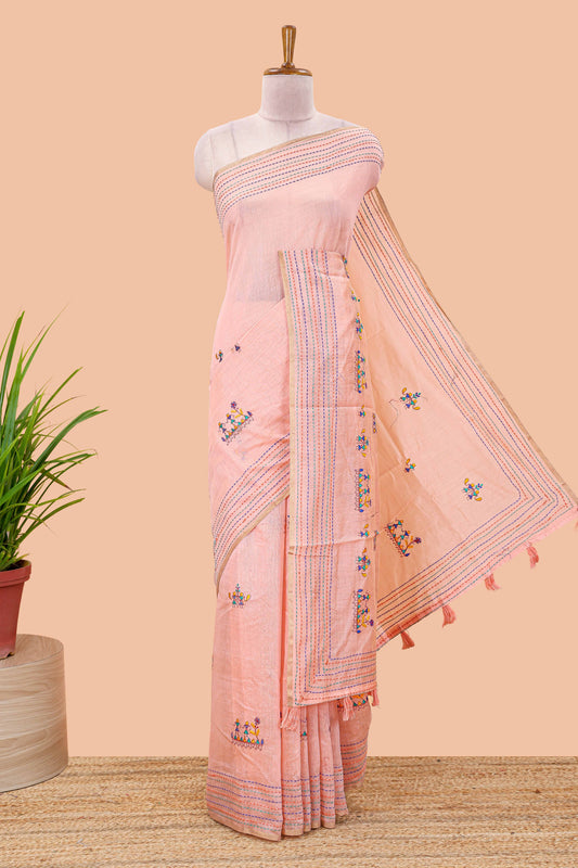 Peach chanderi cotton saree with all over warli style tribal couple embroidery and hand stitched line work