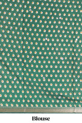 Cream chanderi cotton saree with geometric floral butta, green zari border and patola inspired mirror work