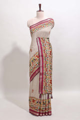 Cream chanderi cotton saree with ikkat style floral butta, pink border and patola inspired mirror work