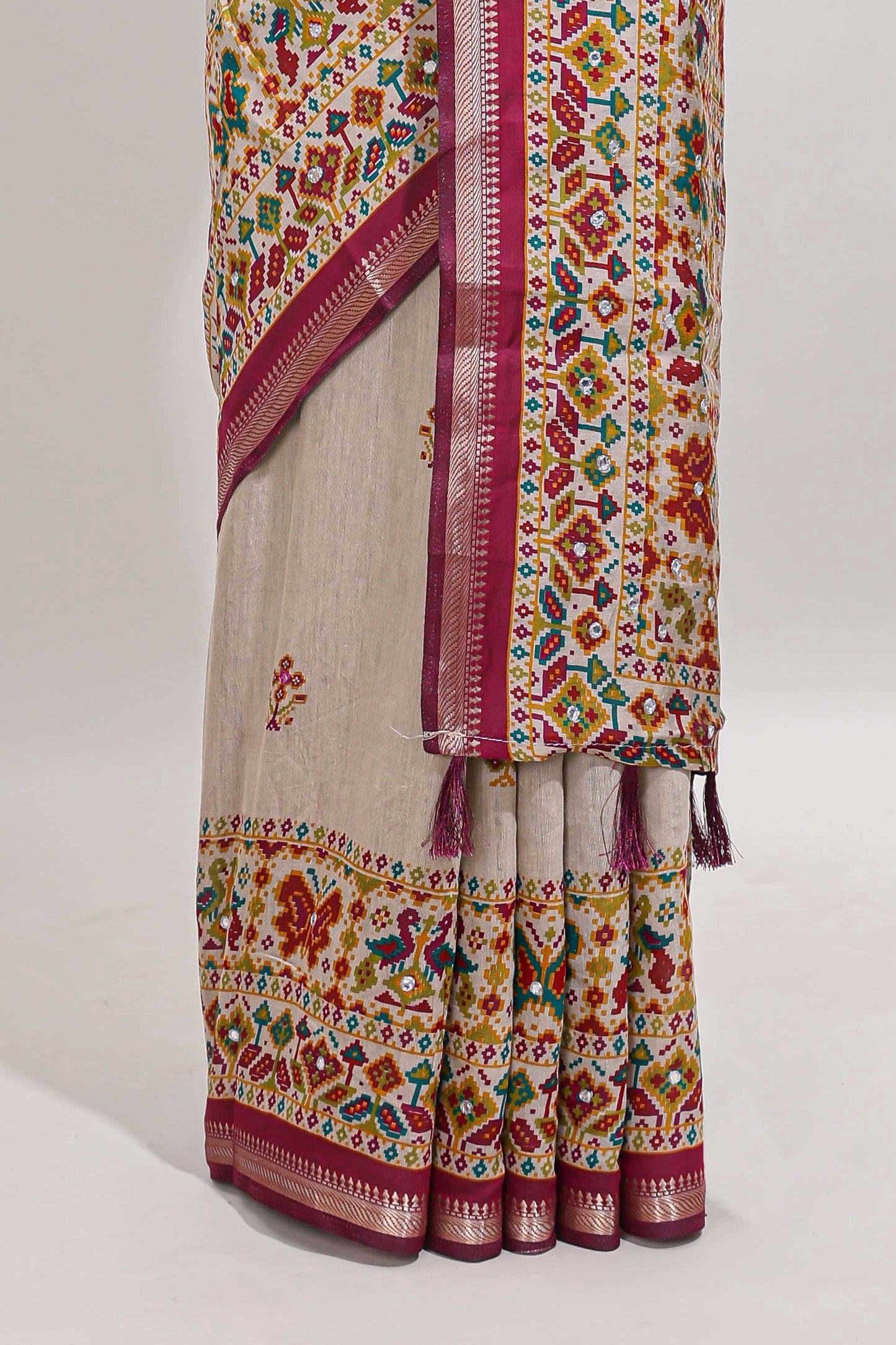 Cream chanderi cotton saree with ikkat style floral butta, pink border and patola inspired mirror work