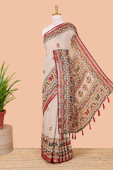 Cream chanderi cotton saree with geometric floral butta, maroon zari border and patola inspired mirror work