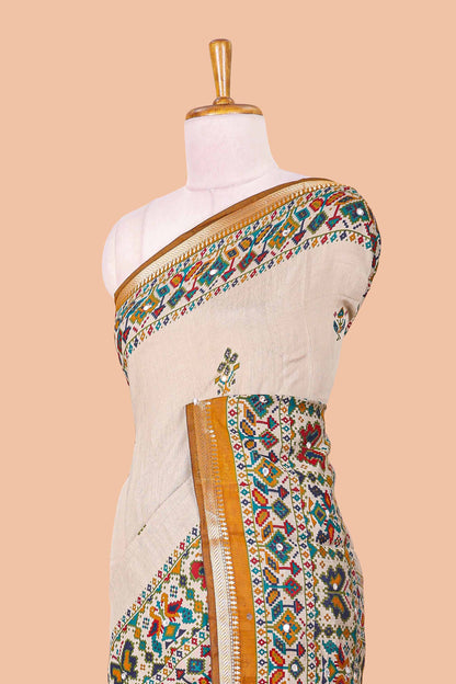 Cream chanderi cotton saree with geometric floral butta, mustard zari border and patola inspired mirror work