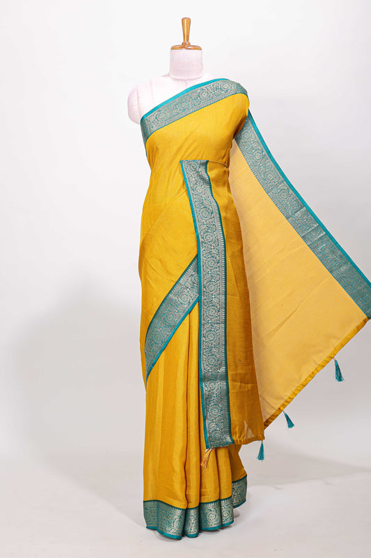 Mustard marsh mellow plain saree with contrast gold zari border and butta blouse