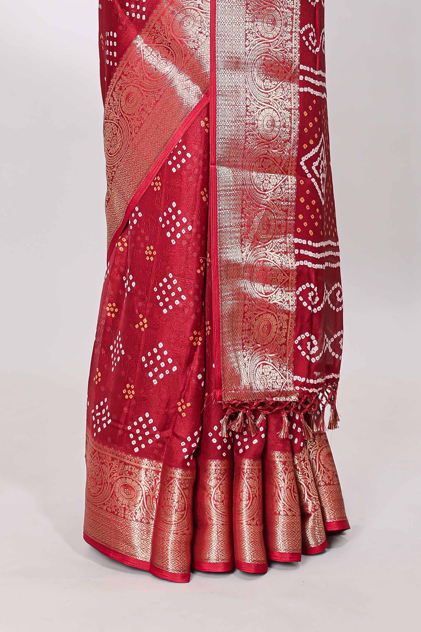 Red marsh mellow bandhani dot saree with gold zari border and butta blouse
