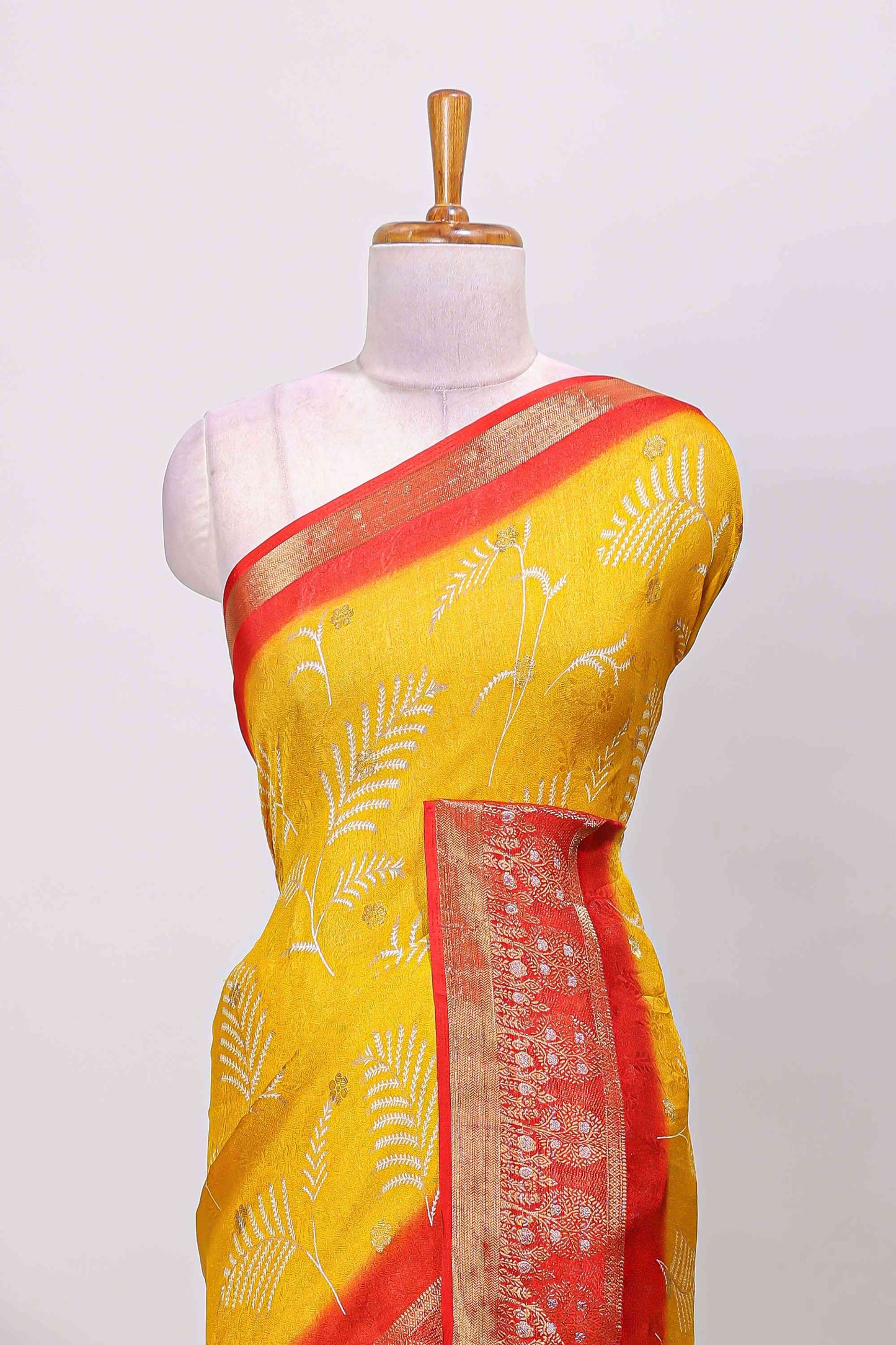 Yellow marsh mellow saree with leaf motifs, contrast border and floral butta blouse