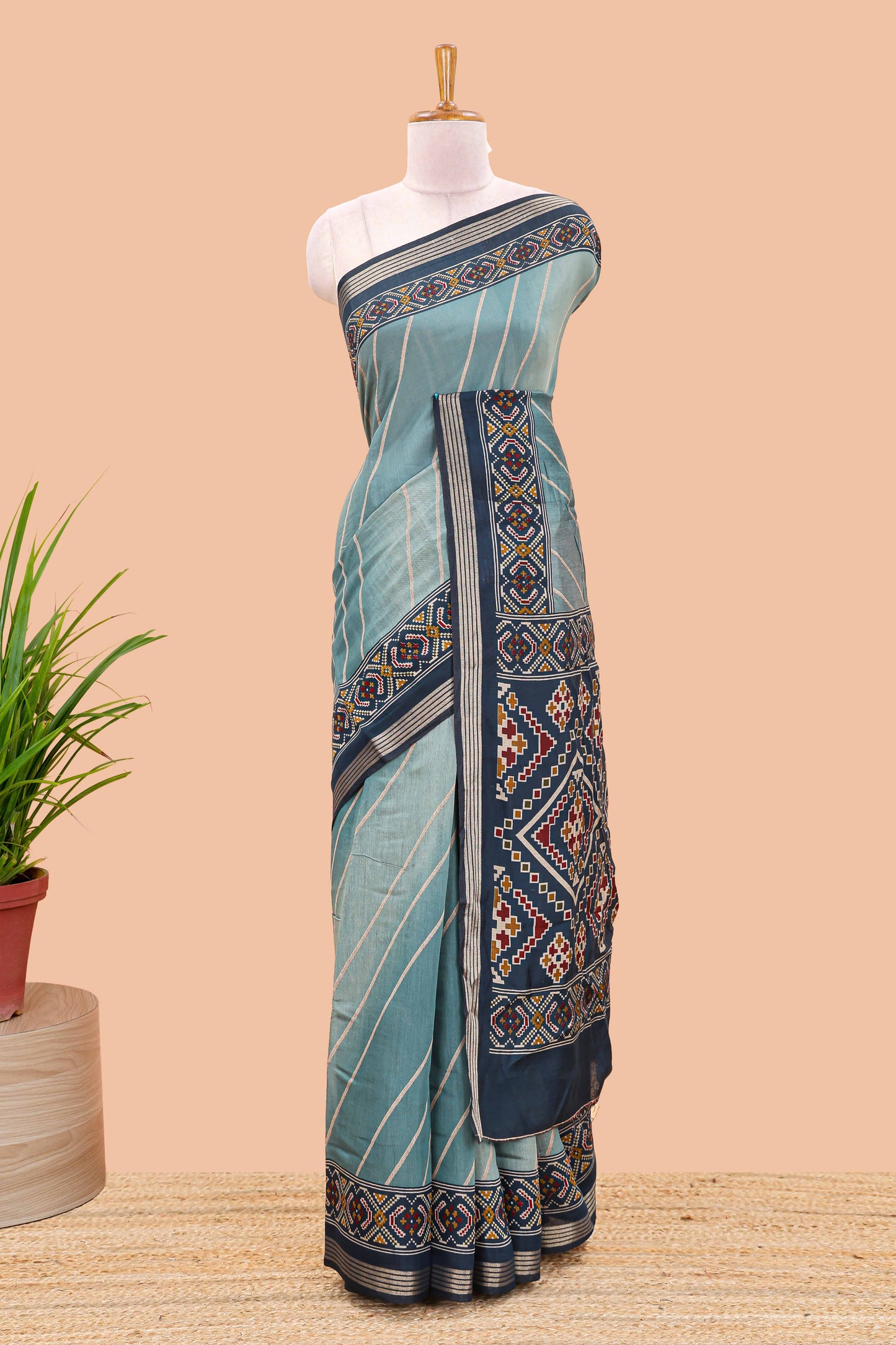 Green chanderi cotton saree featuring diagonal stripes and ikkat print pallu
